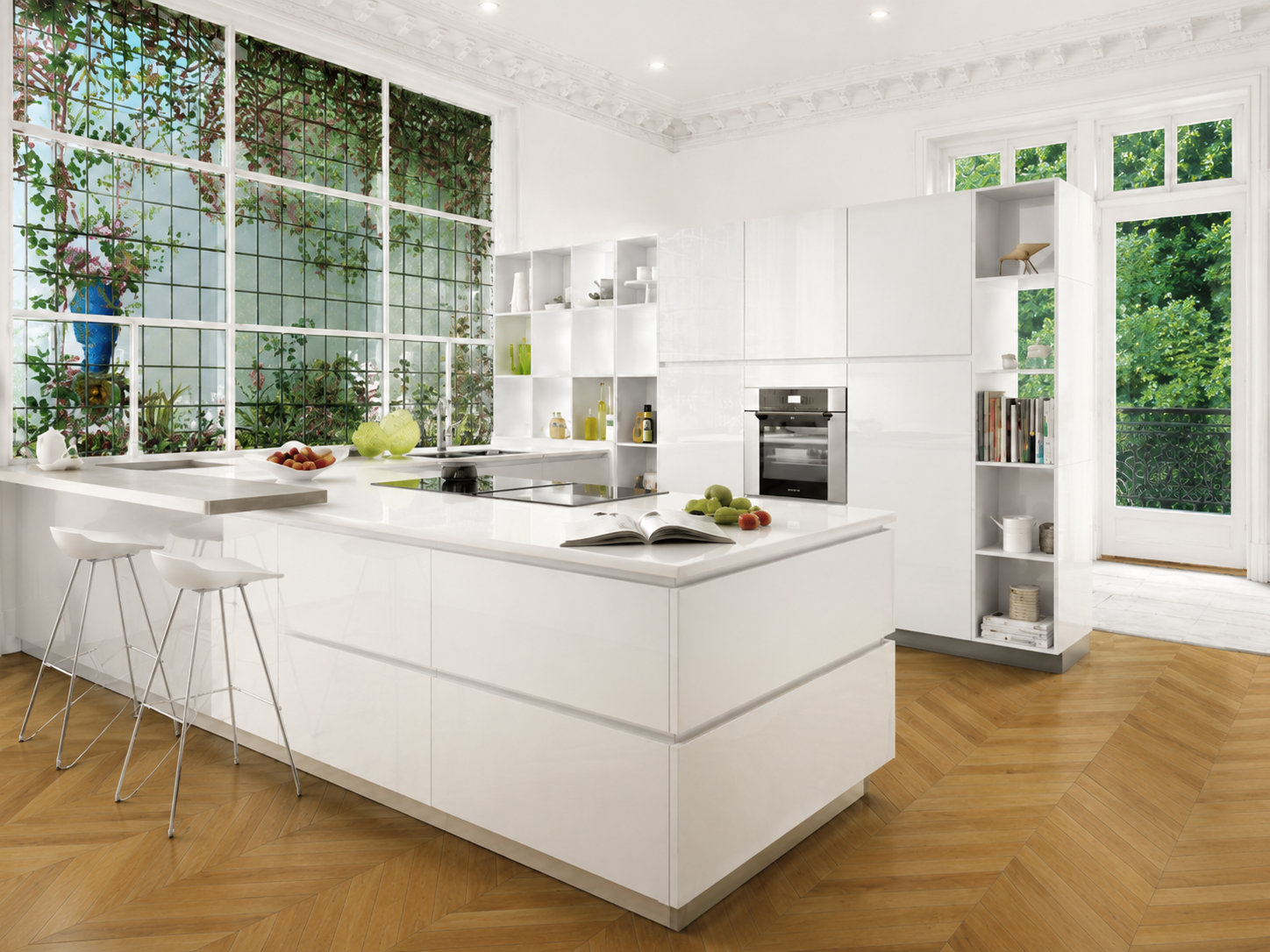 White handleless island kitchen in orangery with garden view