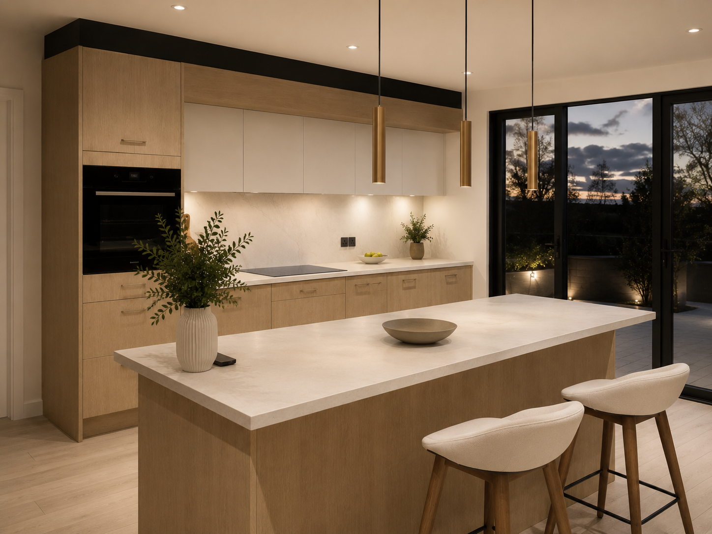 Light oak dining kitchen with brass pendant and pale joinery