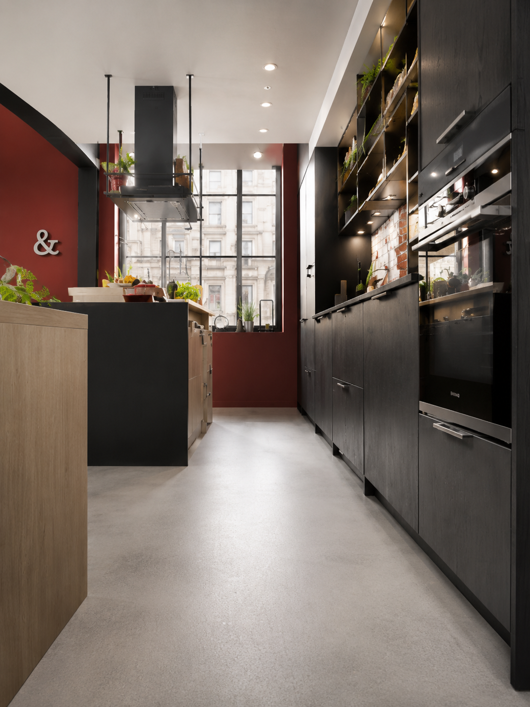 Dark corridor pantry with oxblood joinery and long sight-line